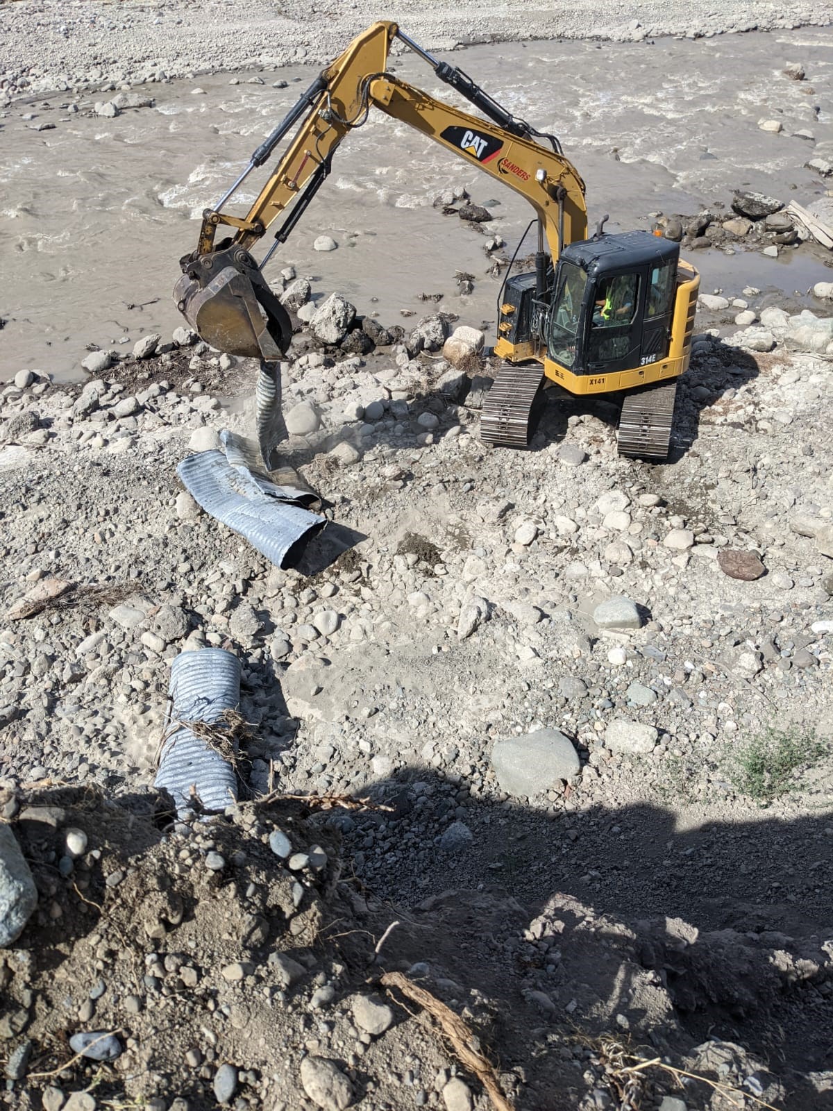 An excavator removes debris along the Nicola River