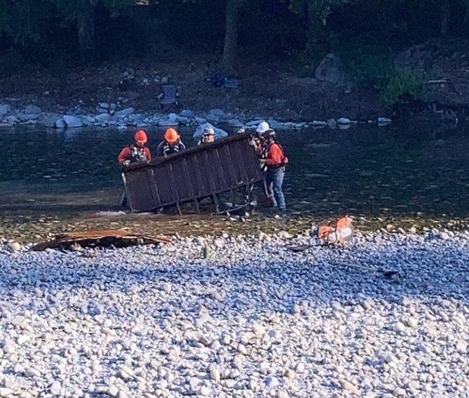Crews remove a trailer frame from the Fraser River
