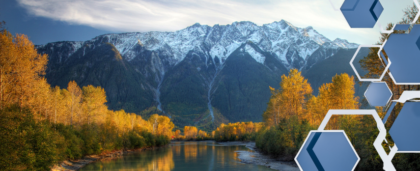 image of snow capped mountains overlooking a slow river with golden trees on its banks