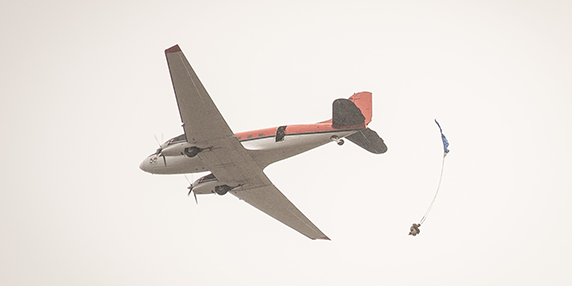 BC Wildfire Service parattack crew member parachuting from an airplane