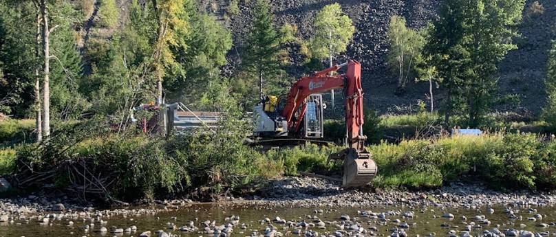 Bank of river with an excavator removing debris