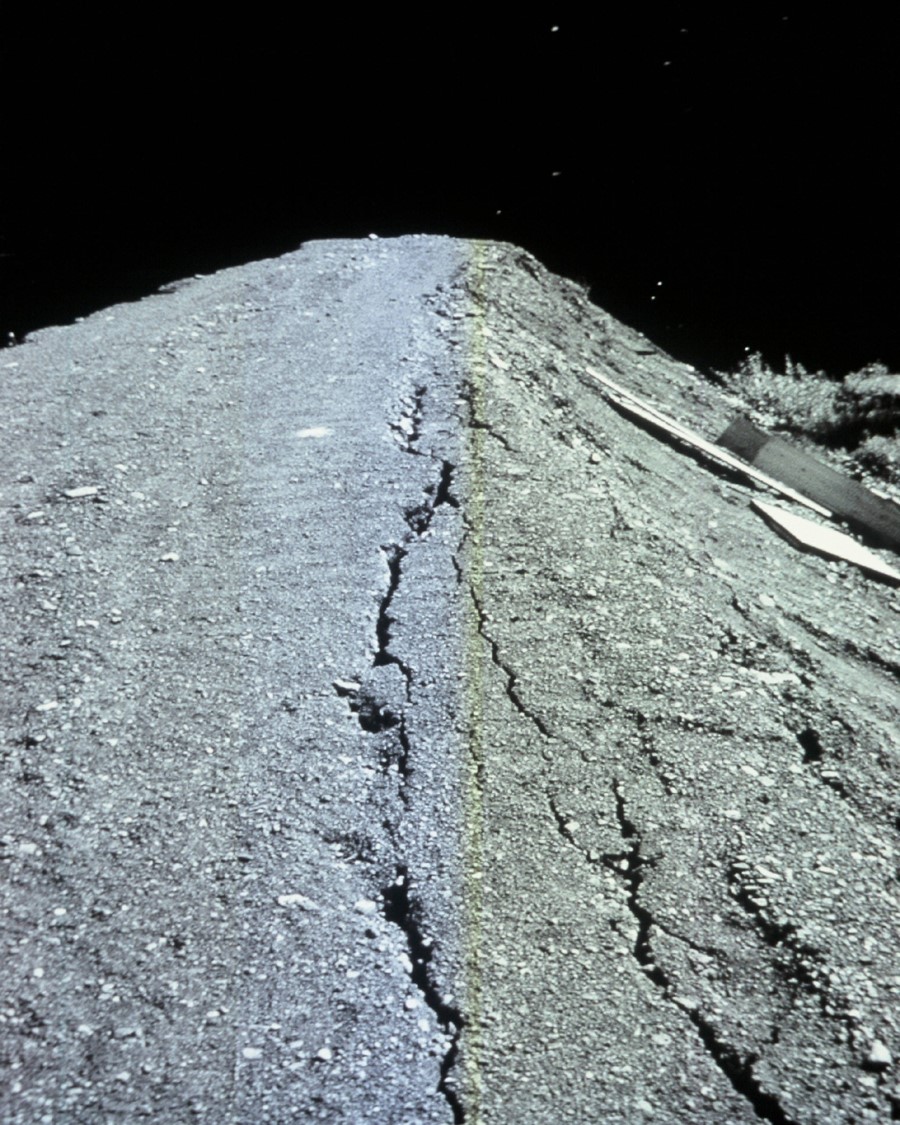 Photograph of large longitudinal cracks on crest