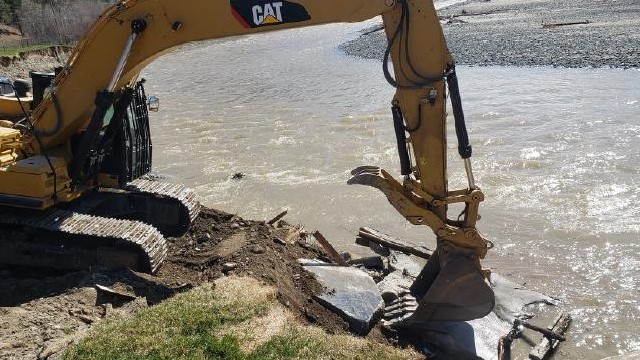 Excavator removed concrete from waterway