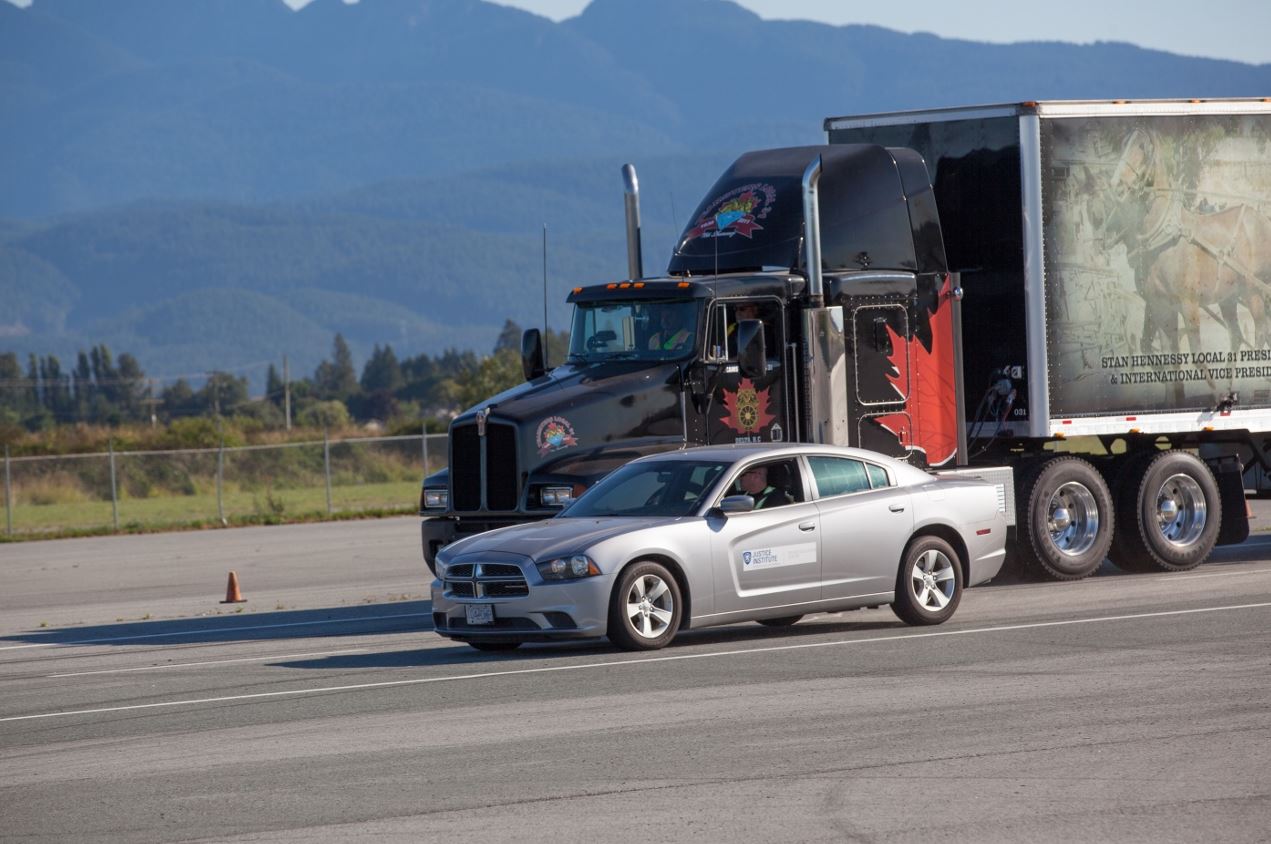 Picture of a commercial truck and car braking