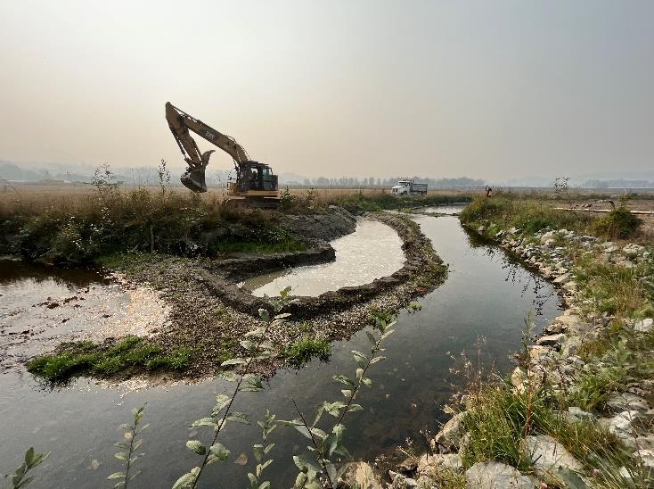 An excavator removes sediment from Clayburn Creek in Abbotsford