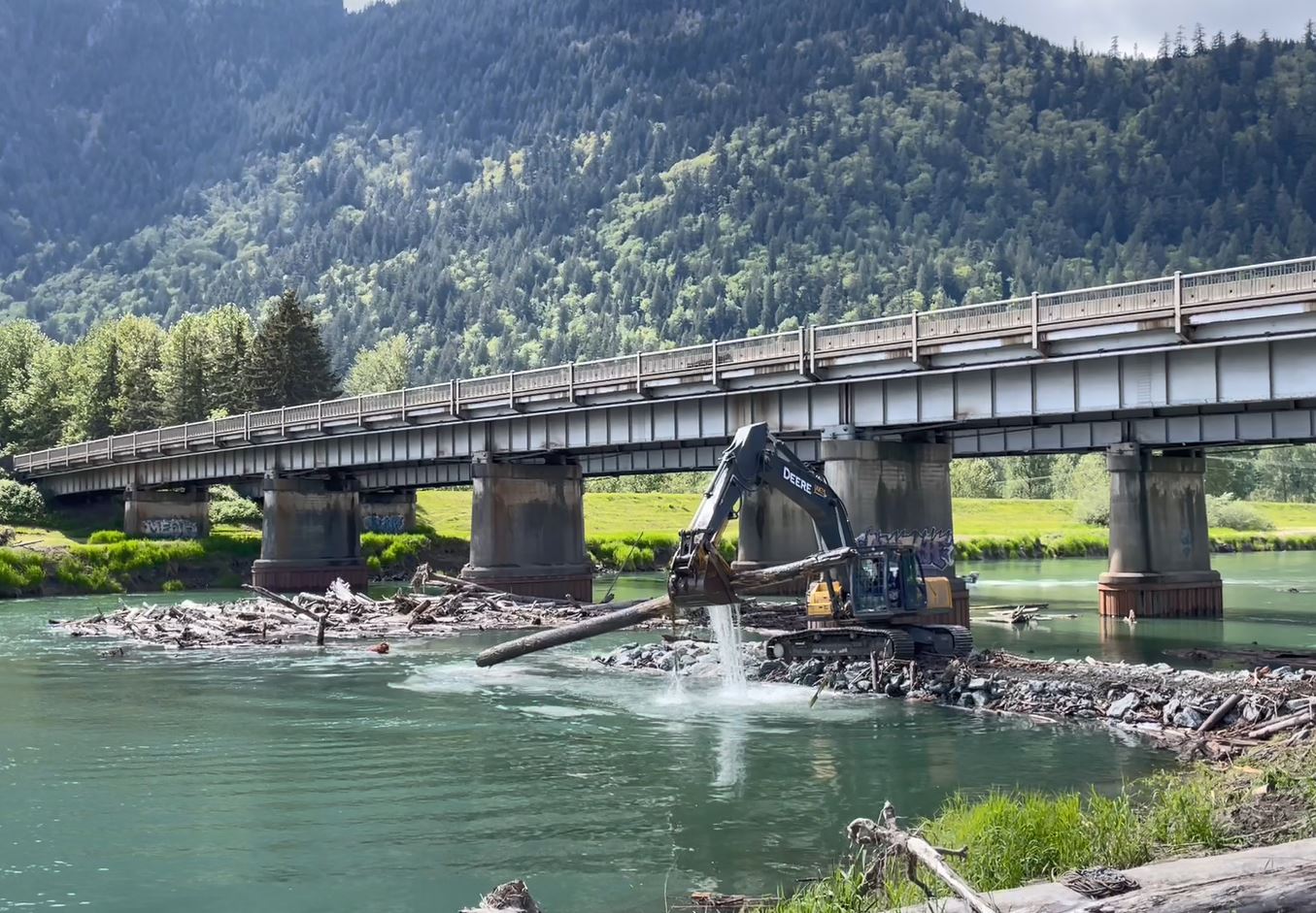 An excavator removes woody debris from the Chilliwack River