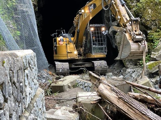 An excavator removes debris from the Othello Tunnels