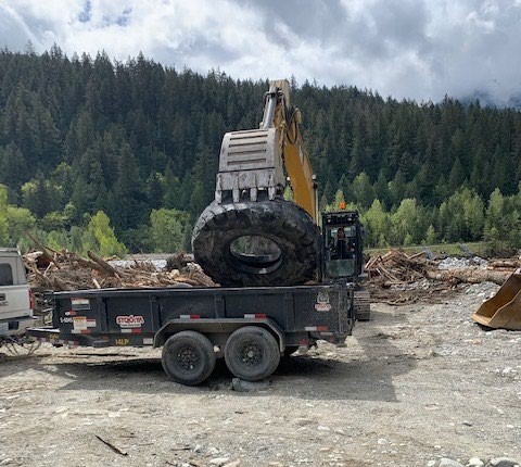 A large tire is removed from the Coquihalla River