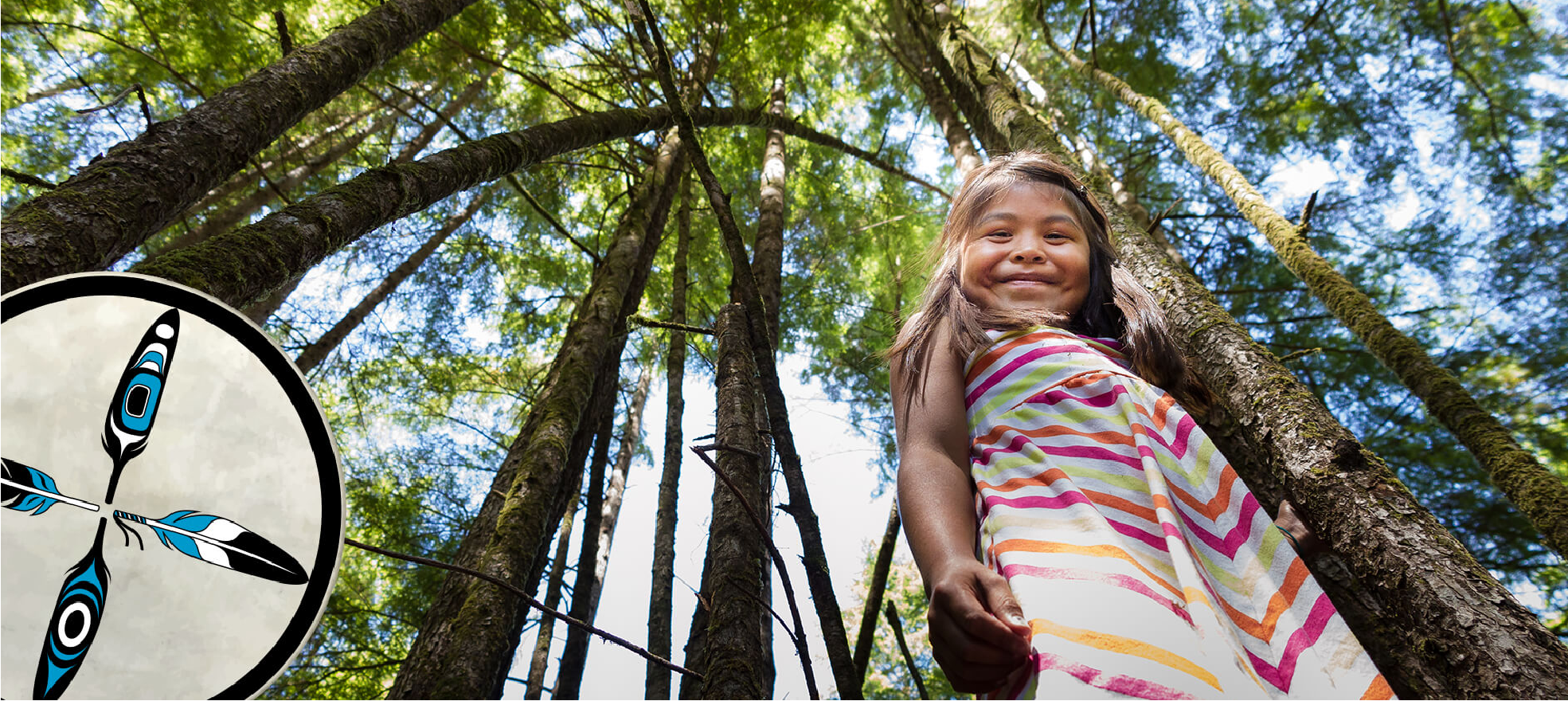 Smiling Indigenous child standing in a forest