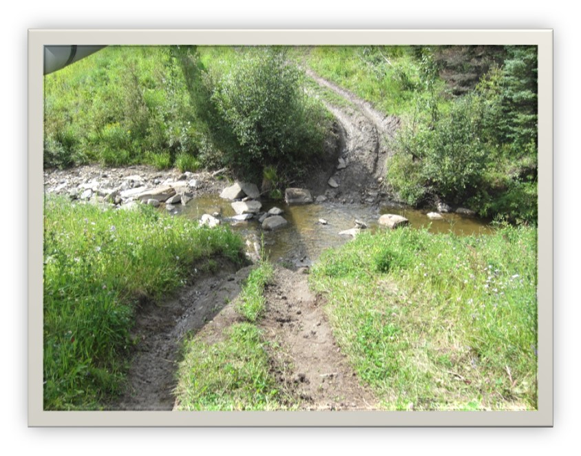 An ATV trail is actively shedding water (and sediment) to the stream