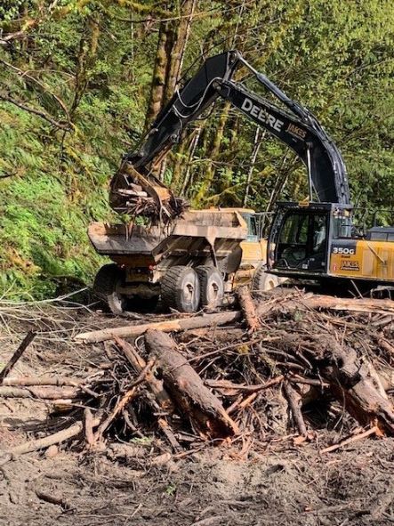 An excavator removes woody debris from the Coquihalla River