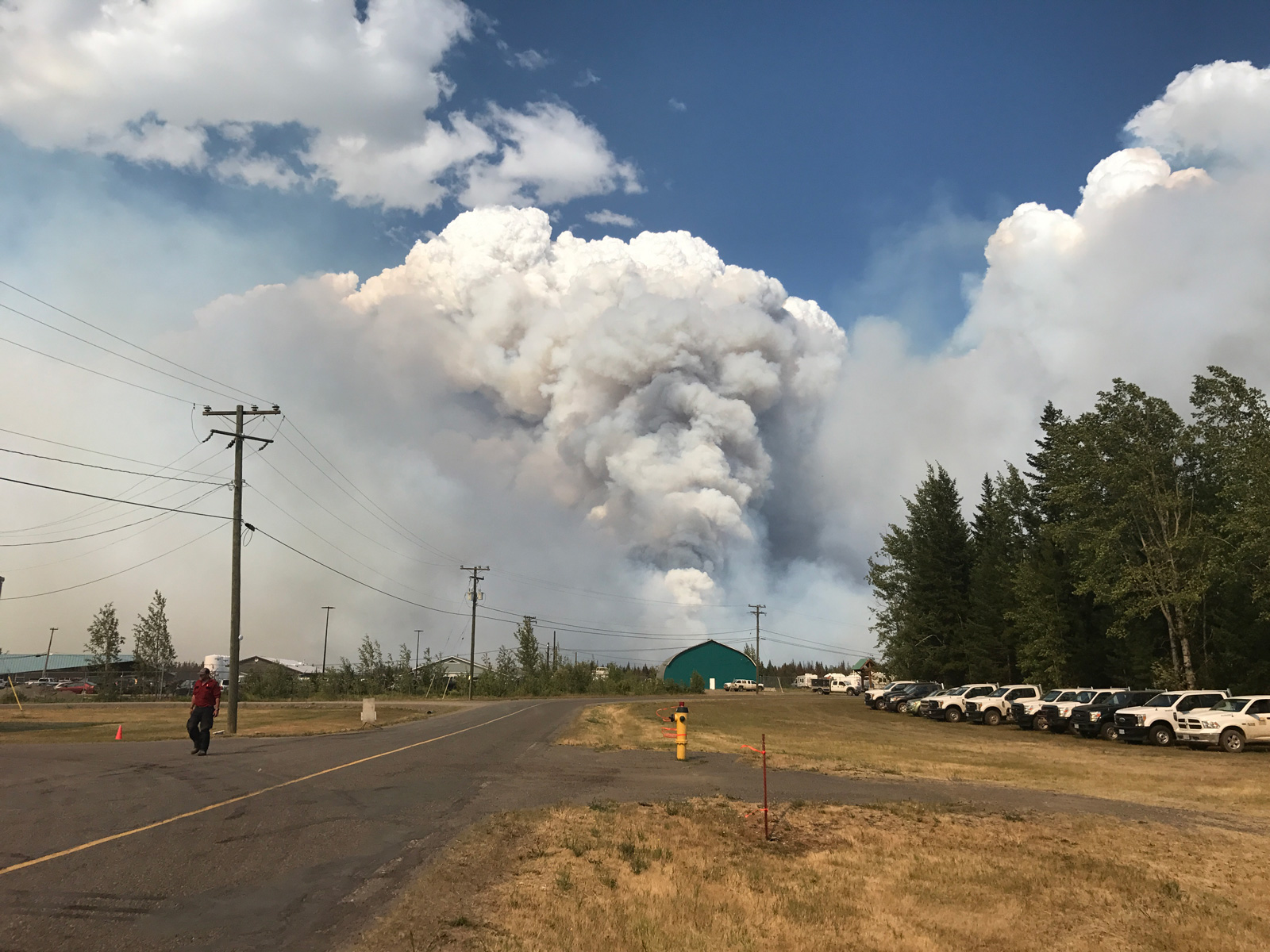 July 7, 2017 looking towards the Williams Lake airport tarmac, with the Cariboo Fire Centre on the left and Dan Houser, Blackwater Unit Crew supervisor, walking to assess objectives. Photo by Brian Clark.
