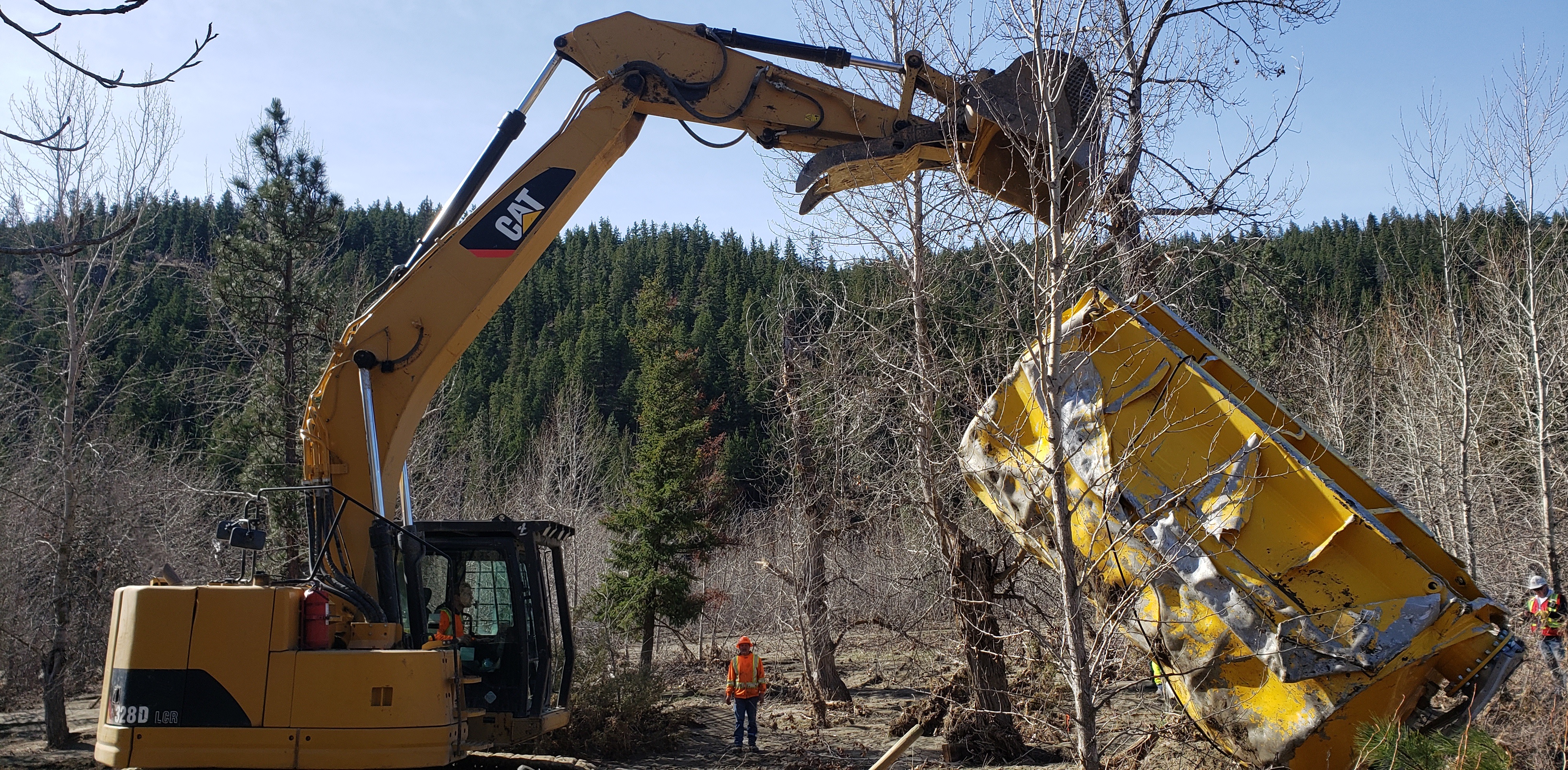 Excavator removing yellow container from Nicola River