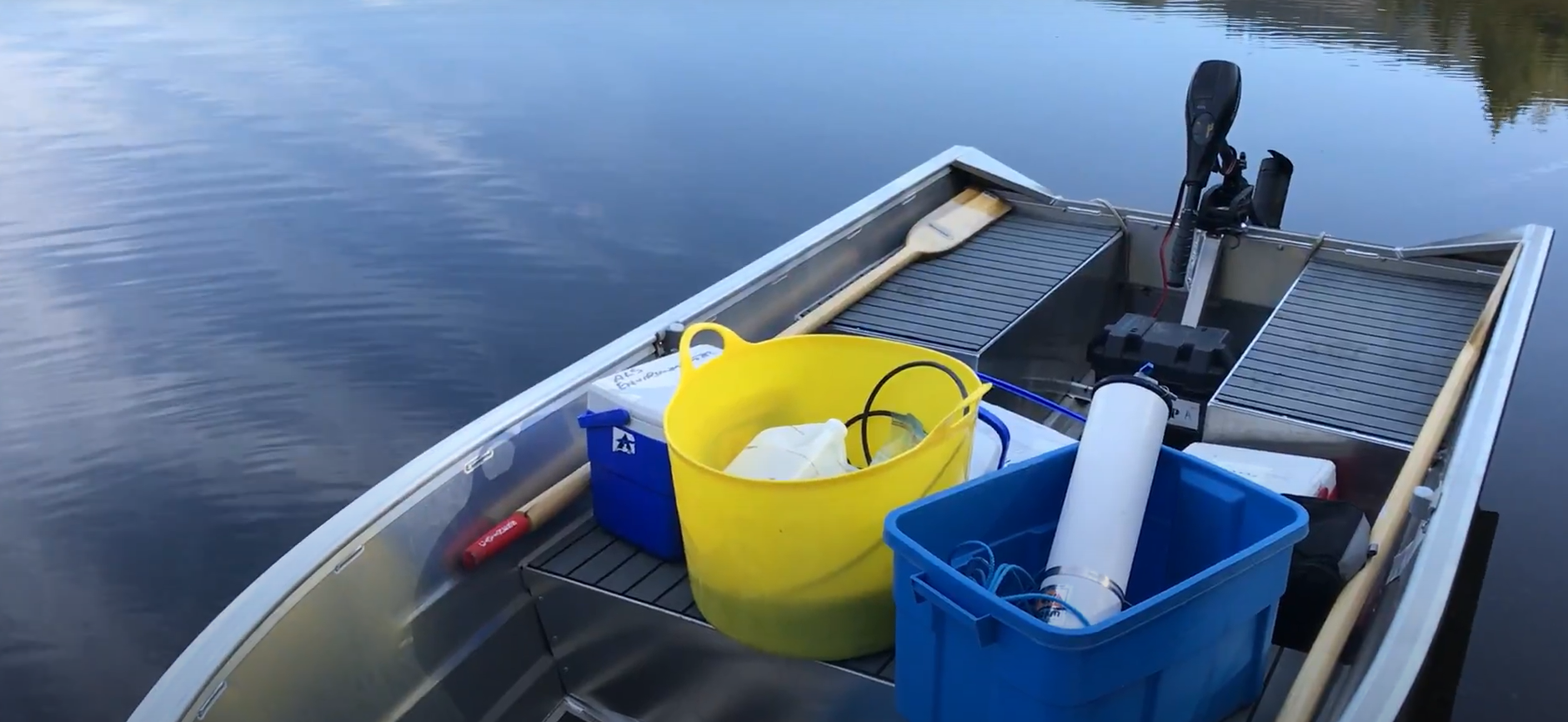 Small powerboat on the water with lake monitoring equipment inside it