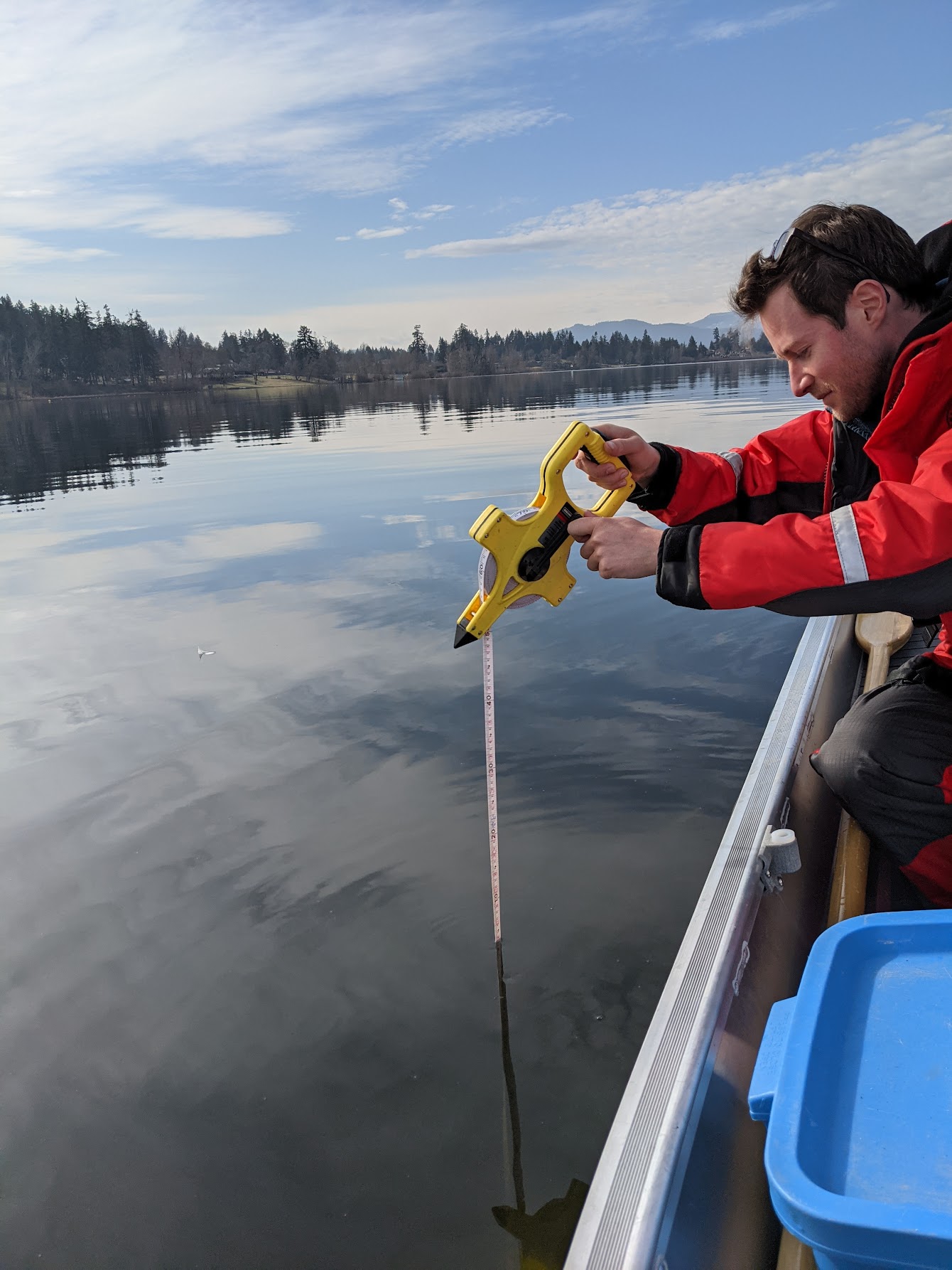 Ministry staff member using a Sechhi disk to measure water clarity.