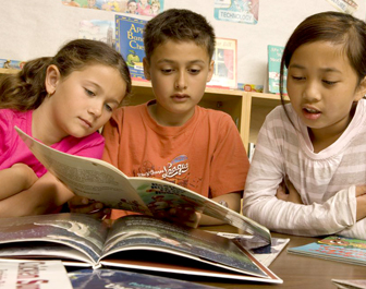 Multiculturalism and diversity in the classroom; students read a book together