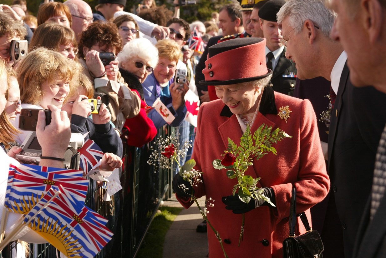 Queen Elizabeth II accepting flowers at the Parliament Buildings in Victoria