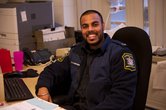 Smiling corrections officer in a chair