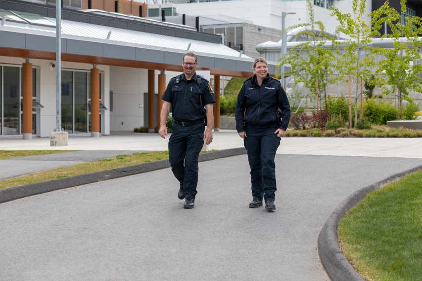 2 correctional officers walking the outside of a correctional centre
