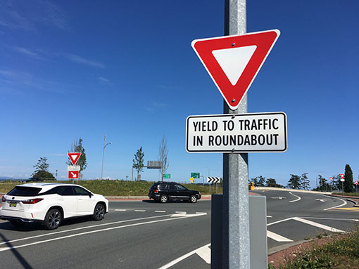 Yield to Traffic in a Roundabout - sign on the side of the road - Link to How to Safely Use Roundabouts in BC on TranBC