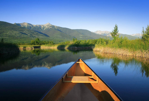 Canoe plowing through still water on a B.C. lake