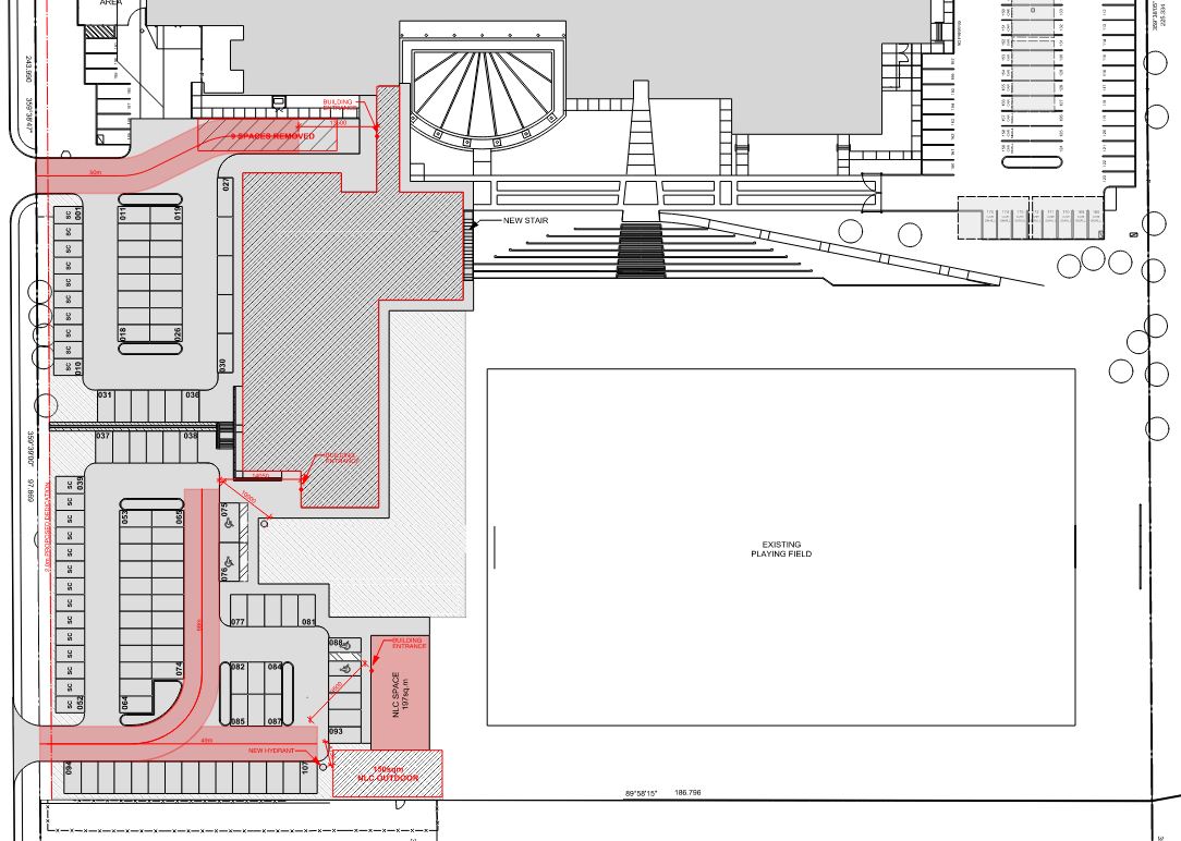 Site plan with new additions highlighted in red, indicating areas of expansion or renovation.