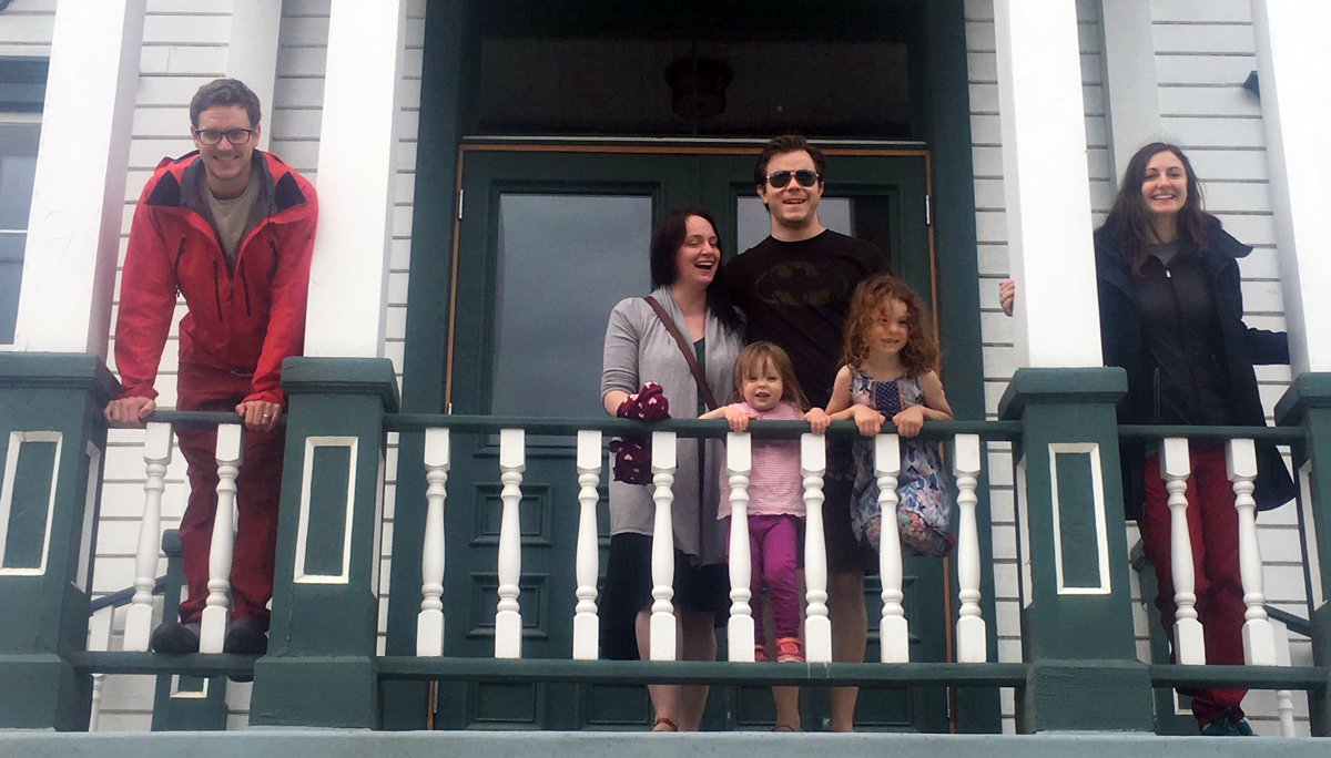 Contest winners standing in front of a historic house