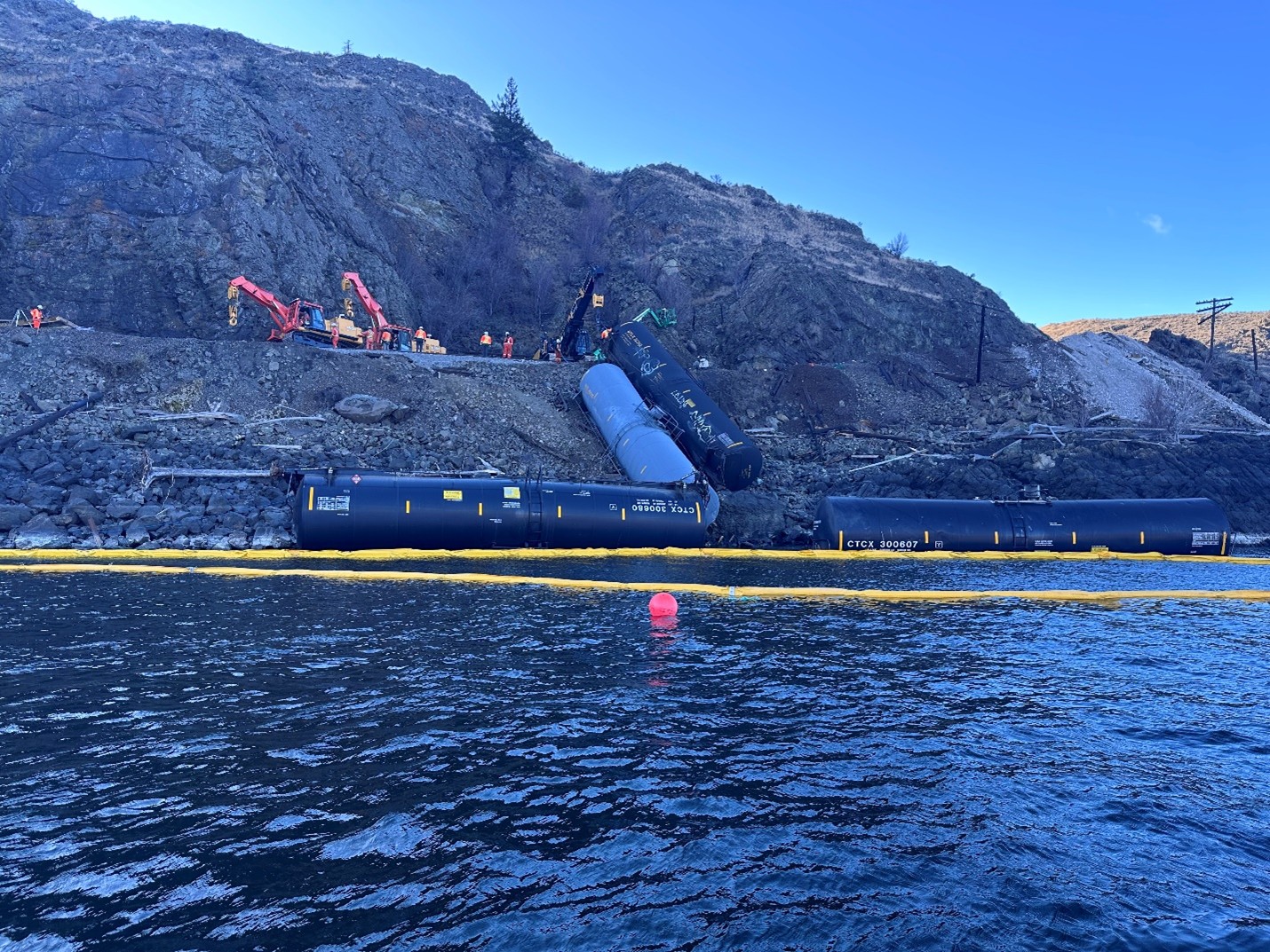 containment boom and derailed cars at incident site