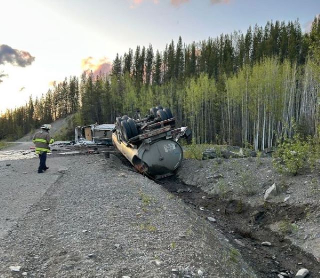truck upside down beside highway