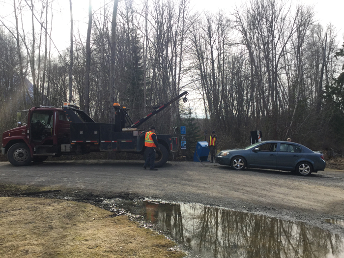 Car being towed away from Ross Lake