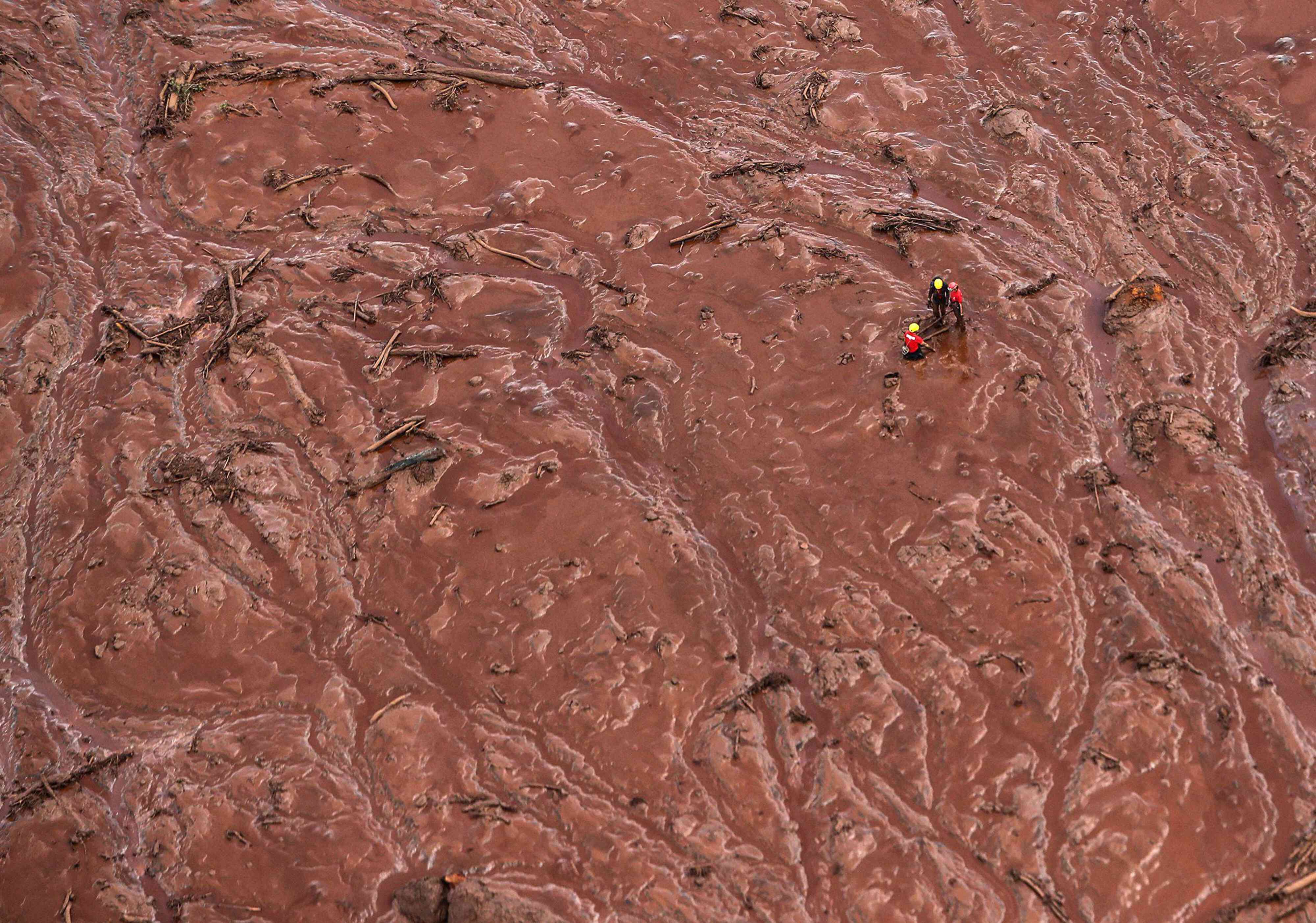 Emergency authorities attempting rescues amidst flooding of mud and debris