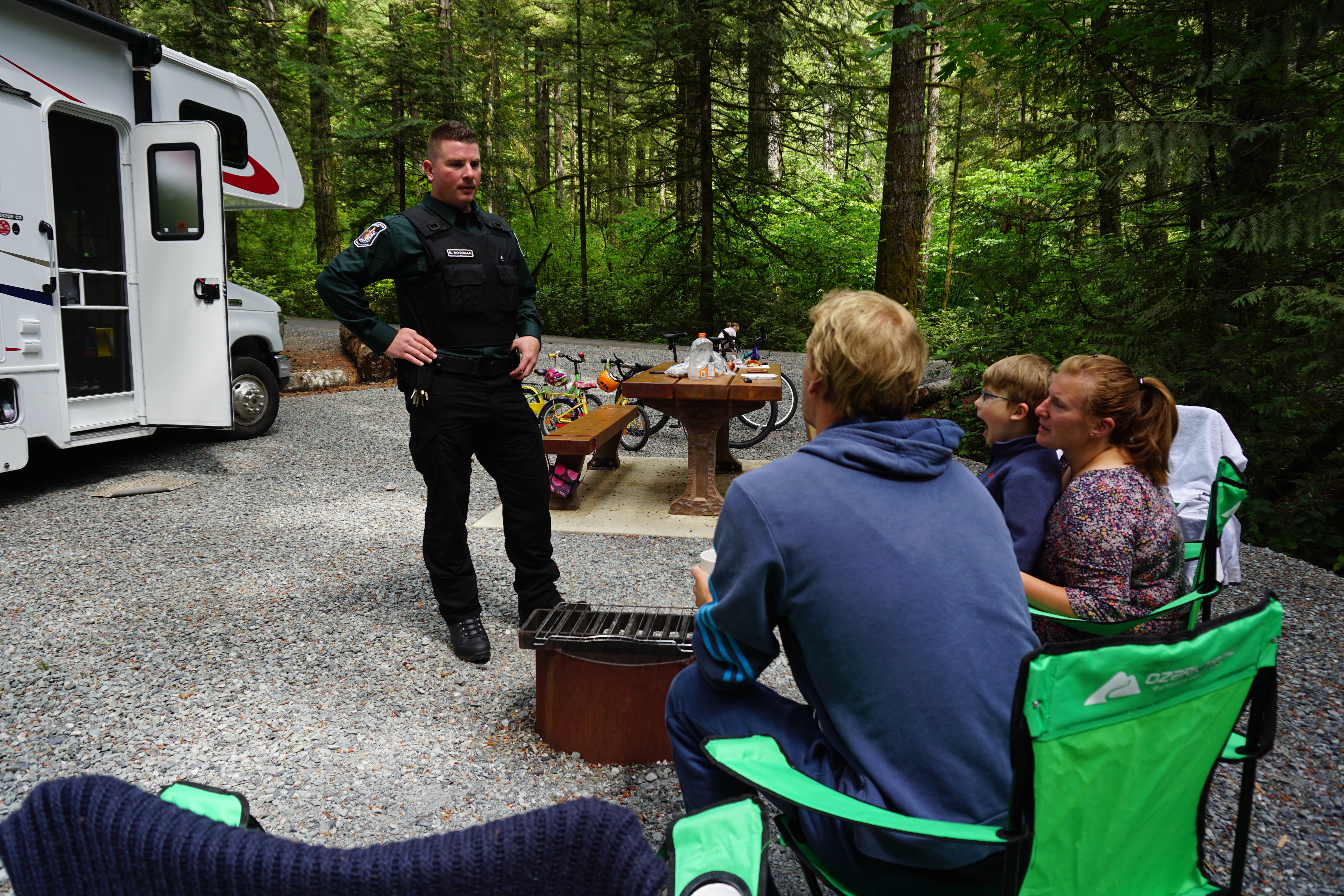 A NRO speaks with campers about their campfire