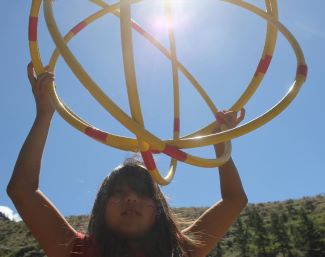 Young girl Indigenous hoop dancer.