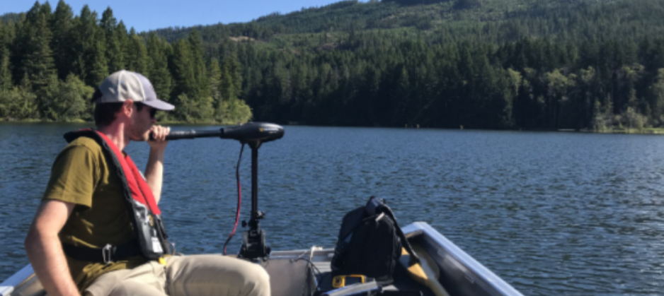 Lake monitoring volunteer driving a boat