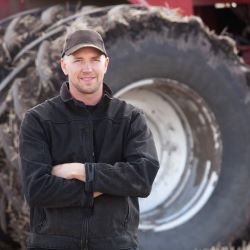 Man standing in front of farming equipment