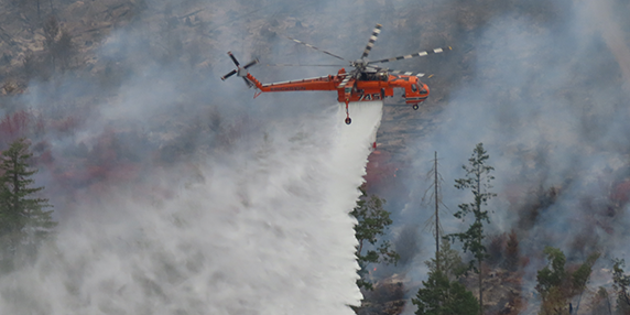 BC Wildfire Service helicopter drops foam on a fire
