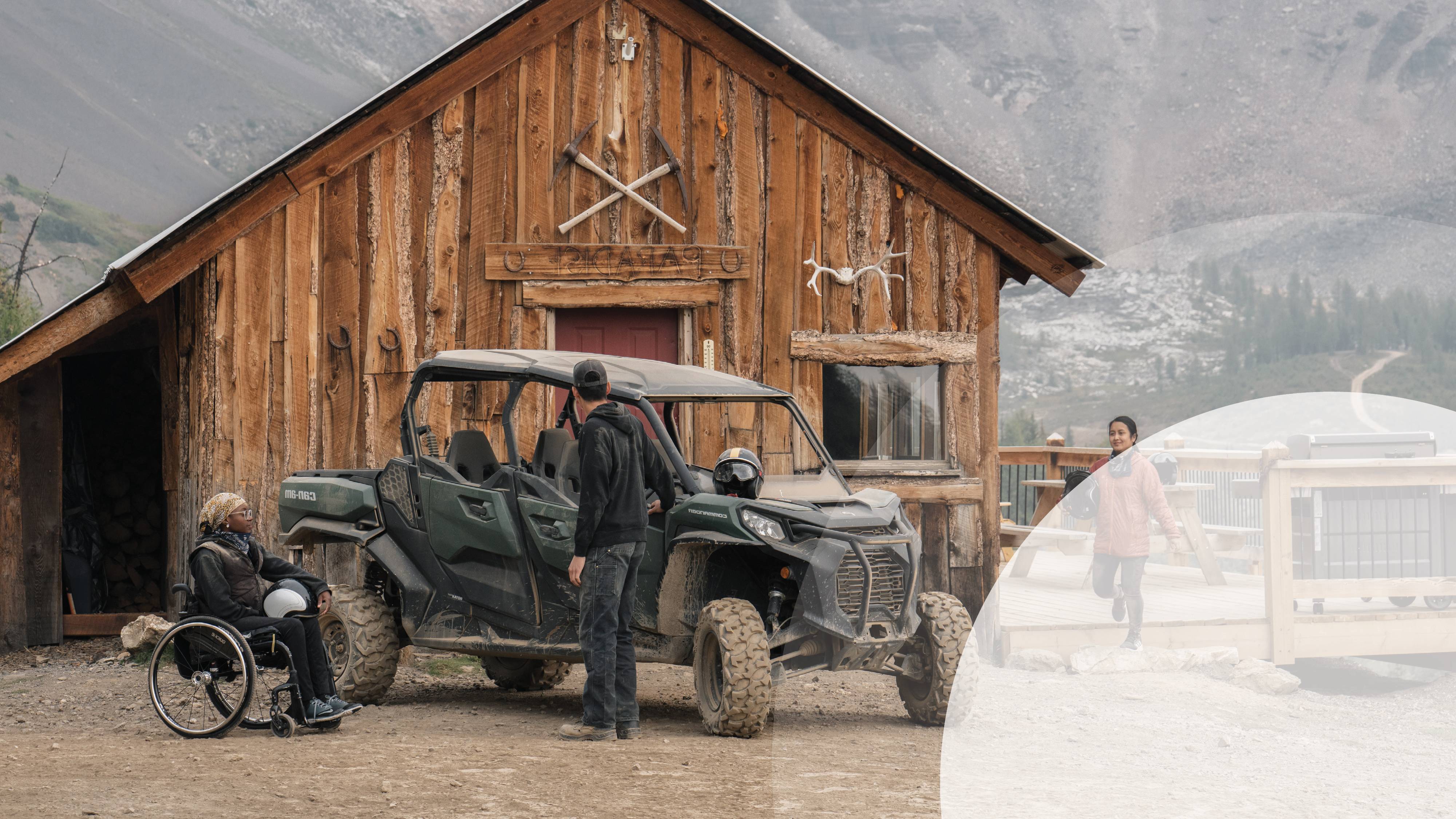 A person in a wheelchair next to an offroad vehicle