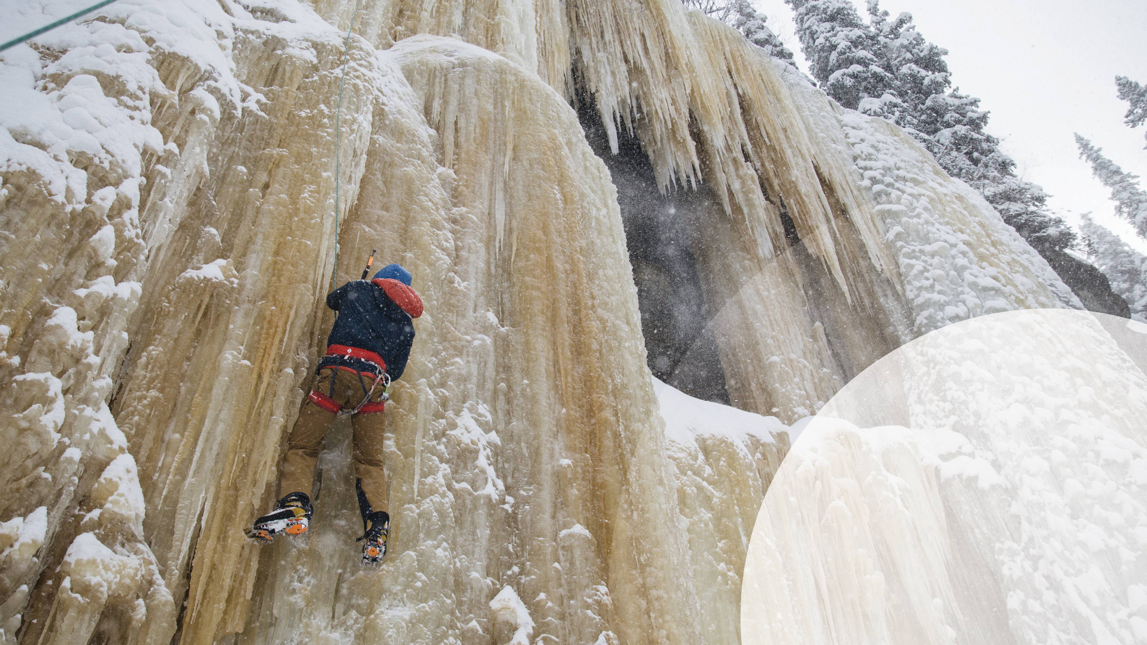 A person climbing an icy cliff
