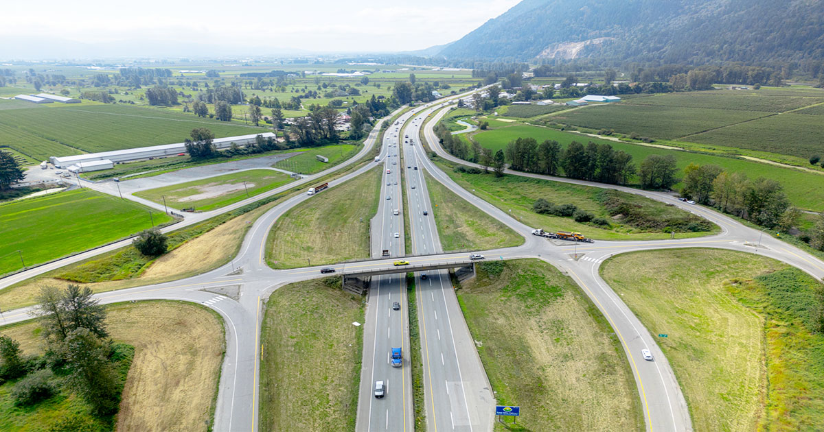 Photo of Whatcom showing four lanes of traffic flowing underneath overhead bridge
